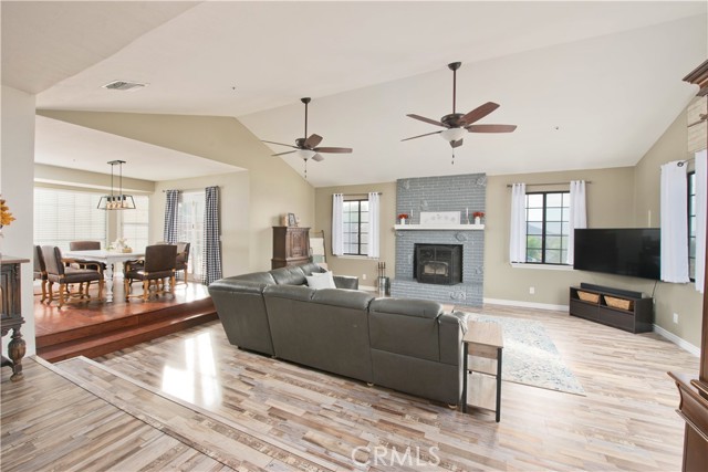 Living Room, vaulted ceilings, wood-burning stove, high-end LPV flooring.