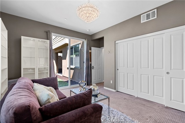 downstairs bedroom with sliding door to backyard