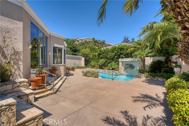 1146 Maybrook Drive Beverly Hills, California Located in one of the prime Beverly Hills/Holmby Hills areas. Re-imagined in 1988 for the original owner of the home by renown Designer Budd Holden. Sky-lighted Formal Entry, Foyer. Powder Room. Grand Great Room with oversized Fireplace, Retractable Glass Sliding Door that opens to the Private, lushly landscaped Yard with Solar Heated Pool. Oversized Formal Entertainers Dining Room with Private Landscaped Patio and Storage Closet. Beautiful Custom upgraded "Cook's Kitchen with Center Island, Full Size Walk-in Pantry Closet, Newer Appliances, Full Size Sub Zero Refrigerator, Full Size Sub Zero Freezer. Limestone Floor. Sun-filled Breakfast Room with Limestone Floor overlooking Private Flower-filled Yard. Custom Built-ins and Wet Bar are featured in the Den which overlooks the Center Piece of this extraordinary Home, the Great Room. The Primary Suite was designed especially for the King and Queen of the Residence! Oversized Bedroom with Custom Fireplace and Built-ins. Niche Art Wall leads into "His" and "Her" Private Bath Suites. Each Bath Suite accesses either a gated landscaped Patio or upper yard Patio. Custom Walk-in Closets, Drawers, Dressing Areas, and a "hideaway" space for office or exercise. Very large Secondary Bedroom Suite with Walk-in Closet and Full Private Bath. Laundry Room includes Washer and Dryer. Full Bathroom and Guest Quarters adjacent. Highly Desirable BHPO neighborhood. Also Available for Lease @ $14,950/month.
