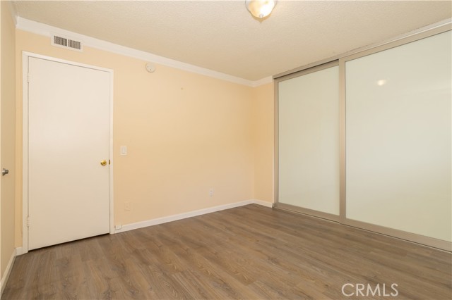 Bedroom with custom closet doors and blinds