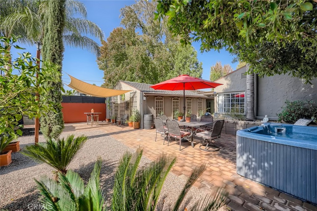10456 Woodbridge Street Toluca Lake, California Welcome to Woodbridge Street in Toluca Lake. Beautifully restored and remodeled 1935 classic traditional on a sweeping corner lot in a highly desirable location. Upon entering the front gate, one is greeted by a lushly landscaped yet drought tolerant private front yard. Through the front door you are greeted with a large beamed ceiling living room with fireplace and original natural finished wood floors as well as accent wall of original shiplap wood and built-ins. The separate dining room with original wainscoting and built-ins is perfect for everyday dining and entertaining. The kitchen has been lovingly restored and updated with original old growth pine flooring. With quartz counters and stainless appliance's as well as a breakfast bar makes this charming efficient kitchen perfect for the chef/s in the in the house. Adjacent to the kitchen is the laundry area and a powder room. Down the stone step is a Den/office with brick fireplace, wood ceiling and wall of French doors opening onto the rear yard and original Sedona flagstone flooring. The private primary suite at the end of the hall features a walk in closet and remodeled bathroom & overlooks the expansive rear yard. The 2nd large bedroom features a walk in closet and bay window. The cozy 3rd bedroom/office features original wood walls and ceiling and a walk in closet as well. The massive rear yard is set up for relaxing and fun with a gazebo, spa, storage/studio as well as the space for an inground pool, ADU/Guest house and anything else one could imagine to make this space your very own private compound, or create income for the future! All of the modern amenities including an oversized garage and storage one would expect in a home today.