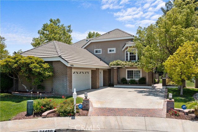 24450 Stonechat Court Valencia, California Beautiful home makes an impressive statement! Great location at end of cul-de-sac. Gorgeous Brazilian cherry hardwood flooring sweeps through the downstairs living areas! Formal living room with crown molding, upgraded baseboards and recessed lighting. Vaulted ceiling in the formal dining room with French doors and lots of windows for an open feeling. Kitchen has been tastefully remodeled and updated with granite counter tops, travertine tile backsplash, stainless steel appliances, lots of clean looking white cabinetry, big breakfast bar, recessed lighting and French doors to the yard. The family room is open to the kitchen and features a slate tiled fireplace, crown molding and raised baseboards. Convenient downstairs bedroom with Berber carpet. Updated bath with granite counter top, dark wood vanity, custom tile work in shower/tub combo with mosaic tile & trim accents. You'll love the big bonus room upstairs that boasts a large area for media options, a built in work station area with multiple stations, dark wood built in cabinetry and library shelving! Master suite with vaulted ceiling, seating area and wood beam accents. Redone master bath features granite counter tops, cherry wood cabinetry, dual sinks and custom tile work. Nice sized secondary bedrooms have vaulted ceilings and upgraded baseboards. Upstairs bath updated with granite counter, cherry vanity and custom tile work in the shower/tub combo. Second bonus room with outstanding separate wine room complete with sliding glass doors, wine racks, granite counter top, wood style flooring and seating area! A true touch of class for all you wine lovers! Upstairs laundry room has lots of storage and a sink. Outside there is an open beam patio cover with paver stone patio and fire pit plus grassy area. Enjoy the good life in this wonderful home!