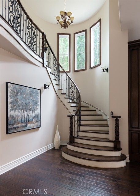 Grand sweeping staircase to primary suite