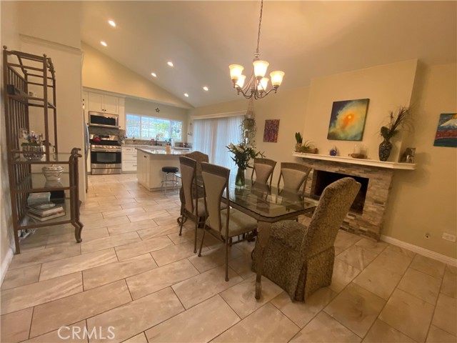 Formal Dinning Area adjacent to kitchen with updated gas fireplace and sliding doors towards side yard