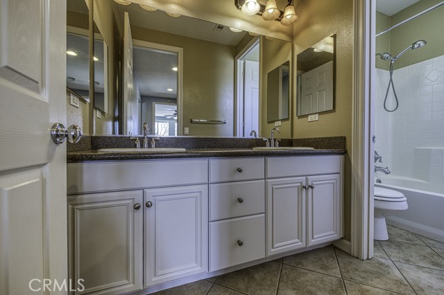 Hall bath with double sinks and separate shower/tub area