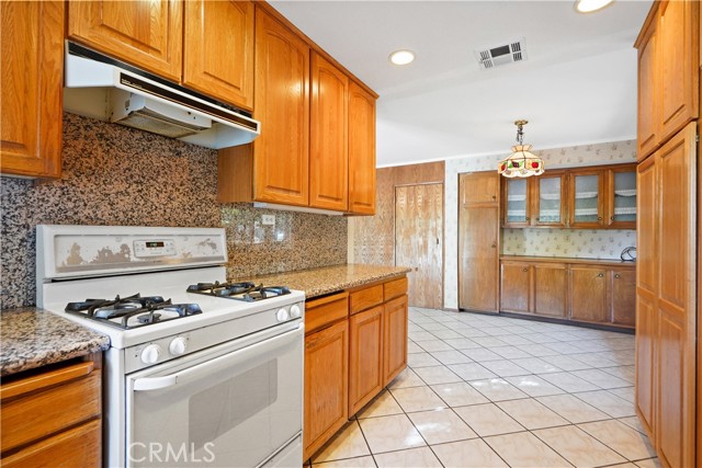 Lookig toward the dine in area of the kitchen, the serving buffet and door to garage