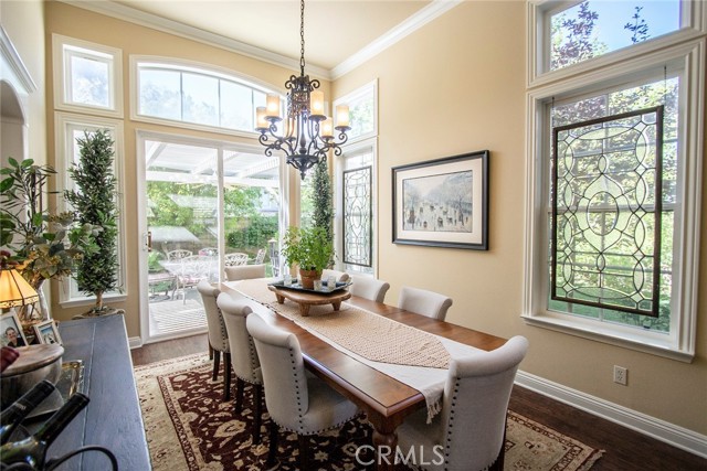 Large formal dining room featuring lots of natural light while overlooking the beautiful gardens.