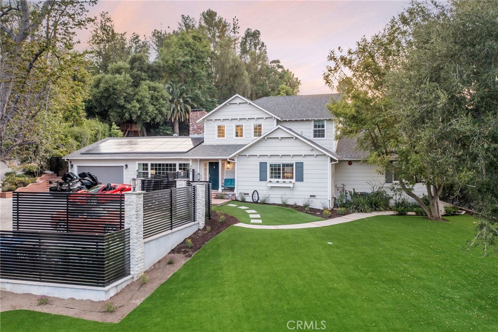 4641 Caritina Drive Tarzana, California Nestled away in one of the most secluded neighborhoods of Tarzana, this stunning home features a characterful & charming exterior, and an almost 27,000 SF private lot. Absolutely captivating, this home has been meticulously maintained and extensively renovated with some of the latest tech and energy efficient items including an owned 16 KW solar array integrated with 4 Tesla Powerwall battery back-ups, new electrical panel, drought tolerant landscaping, new blown-in attic insulation, 20-26 SEER HVAC systems with smart thermostats, and LED lighting throughout. This property is perfect for the entertainer and car enthusiast alike, boasting a 2-car garage with epoxy coated flooring, custom cabinetry, stacking car lift (negotiable), and an expanded driveway that allows for parking of 7 cars (including garage) without obstruction or up to 13 cars without blocking the street. The spectacular floorplan offers a formal living room with wood-burning fireplace, inviting open-concept dining-kitchen-living areas perfect for entertaining, and indoor laundry. The gorgeous kitchen includes shaker cabinetry, quartz counter tops, peninsula island with seating, and stainless Viking appliances. There are 2 bedrooms on the main level including the spacious primary bedroom which includes high ceilings, dual walk-in closets, and reading nook along with the large ensuite bath offering dual vanities, separate shower, relaxing soaking tub, and direct access to the rear yard. Upstairs you will find a loft/bonus area perfect for an office, or play room, and 2 additional guest suites with an updated full bath. Every room is filled with natural lighting, and surrounded by beautiful views of the lush greenery. This incredible home is situated in the middle of the expansive fully-fenced and fully-usable lot. The back yard, which trails up to a relaxing saltwater pool/spa with safety fence, features cool-to-the-touch decking with built-in seating and storage, firepit, shaded pergola, dual illuminated stairways, lush low-water lawn, large play area, and mature fruit trees. The front yard is a massive virtually zero-maintenance paradise with new turf, drought-tolerant flowers, mature oak/pine trees, and a contemporary iron fence with stone-faced and illuminated columns. It is truly the idyllic retreat to enjoy the amazing California outdoor lifestyle!