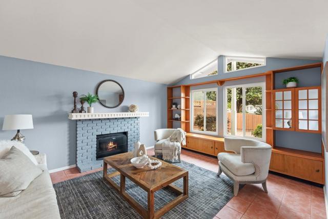 Living room with vaulted ceiling and fireplace. Built-ins