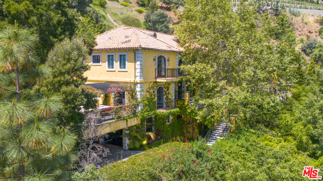 1246 LAGO VISTA Drive Beverly Hills, California European classic meets Beverly Hills glamour in this Chateau retreat! Nestled amongst mature trees, and reminiscent of Italy or France, this gem invites the outdoors throughout the inside of the home with scores of French doors throughout. You will be stunned by the double staircase entry, high ceilings, exquisite ensuites and luxurious bathrooms. This beauty features French limestone flooring, coffered ceilings, an open floor plan, luxurious living space, gourmet kitchen, a pool, and a large outdoor dining and entertaining space that is truly magical. 5 ensuite bedrooms bring an elegant yet comfortable feel to this luxury estate. Come experience this completely private, beautifully serene property, just minutes from the city - making you feel like you've acquired the best of both worlds.