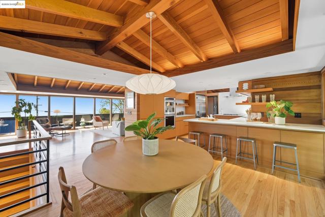Dining area with wood ceiling and light wood-style floors