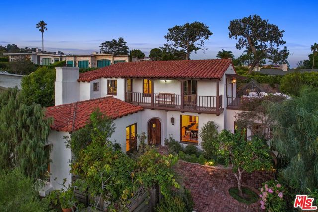 216 Notteargenta Road Pacific Palisades, California This beautifully restored 1920's Spanish home is a rare offering that invites you to experience the best of the coveted seaside Castellamare living in Pacific Palisades. Enter through the custom front gate, ipe wood steps and winding pathway to an enchanting brick courtyard with a sitting area and mountain views. This light filled home boasts generous living spaces. The formal living room, dining room and den all overlook the brick courtyard. Enjoy family & holiday dinners in the spacious dining room. The gourmet cook's kitchen with an eat-in breakfast area leads you to the sunken den complete with built-in shelving and walnut paneling. Situated on an approximately 7,330 sq ft flat lot lies an organic vegetable garden, fruit trees and a stunning 18'x60' glass greenhouse in the private backyard. The backyard is completely enclosed by 12 ft privacy fence. Enjoy beautiful ocean views from the primary suite and oversized wood deck. Two additional bedrooms complete the second floor with the fourth bedroom downstairs. The Castellammare neighborhood is a well kept secret with ocean and mountain views. While close to the dining and shopping in the Village, it offers a private and tranquil setting making it truly an idyllic retreat.
