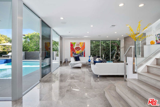 This newly reimagined contemporary masterpiece, as featured in "Million Dollar Listing," is located in the prestigious Beverly Hills and Holmby Hills area. Capturing breathtaking vistas, this property showcases voluminous living spaces and unprecedented finishes. Designed for entertaining, an open floor plan is highlighted by towering ceilings and sliding walls of glass and resort-caliber pool, spa, and entertainer's terraces with cascading waterfalls throughout the house. A sprawling great room with a fireplace that opens up to a built-in fully equipped bar with top-tier temperature-controlled wine storage. This flows to a gorgeous dining room and sophisticated chef's kitchen with Miele appliances and Poggenpohl cabinets. The stunning master suite is replete with a private terrace with views, showroom closets, exquisite dual bathrooms, three oversized VIP guest suites, a state-of-the-art media room with views, and a gym with a dry sauna. Complete this extraordinary high-tech smart house retreat. *Seller financing available.