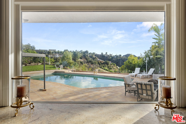 9606 Arby Drive Beverly Hills, California Great opportunity in prime BHPO to customize this light-filled mid-century w/ stunning views. An open, sun-drenched floor plan w/ high ceilings & great flow for formal or informal entertaining, where the kitchen opens to the breakfast room, family room & dining room, all opening to the huge backyard w/ seemingly endless views. Sitting at the end of a quiet cul-de-sac w/ 4 bedrooms & 3.5 bathrooms, two large living areas, a step down bar, formal yet open dining room flooded w/ natural light. The main suite also has direct access to the backyard & views. Great indoor/outdoor flow w/ walls of glass leading to the pool, grass area & large hardscape patio for grand-scale entertaining. Just moments from the heart of Beverly Hills, the best of the valley & the great restaurants & shops at the Glen Centre, in coveted Warner Avenue Elementary.