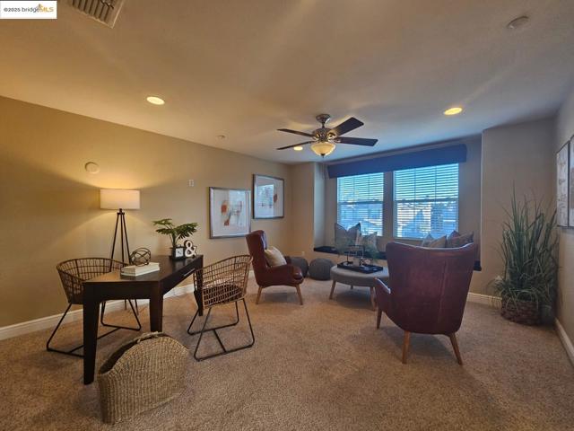Office area featuring light carpet, recessed lighting, and a ceiling fan