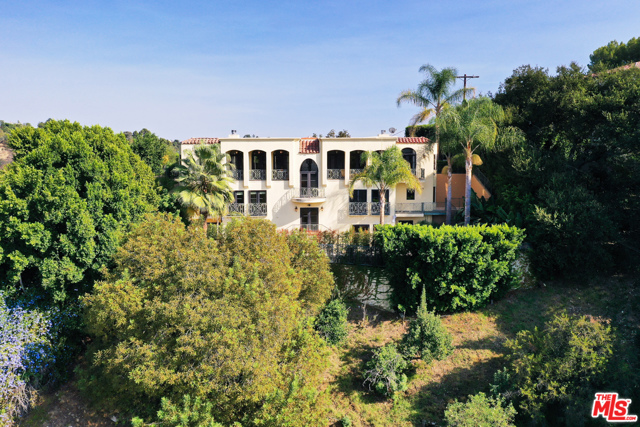 3110 Benedict Canyon Drive Beverly Hills, California Never miss a sunrise or sunset from this very private home with unobstructed views from both east and west, nestled on a hilltop on a private road off Benedict Canyon Drive. This three story home has an elevator. Living and Dining rooms feature stone floors, fireplaces, and terraces with verdant views which span the house. Large kitchen features oversized island, granite counters, stainless appliances and a walk-in pantry. There's an office, family room, gym, media room, and 1,200 bottle wine cellar in solid walnut. The fully remodeled master suite with cherry hardwood floors includes a large custom closet, remodeled bathroom with steam shower and Japanese-style bathtub. Three additional en-suite bedrooms. Resort style backyard with non-chlorine ionized swimmers' lap pool, spa, outdoor kitchen, and entertaining area with fire pit. Filtered water system, smart home automation for in-ceiling speaker systems, TVs, thermostats, and cameras. Rare mix of privacy and access.