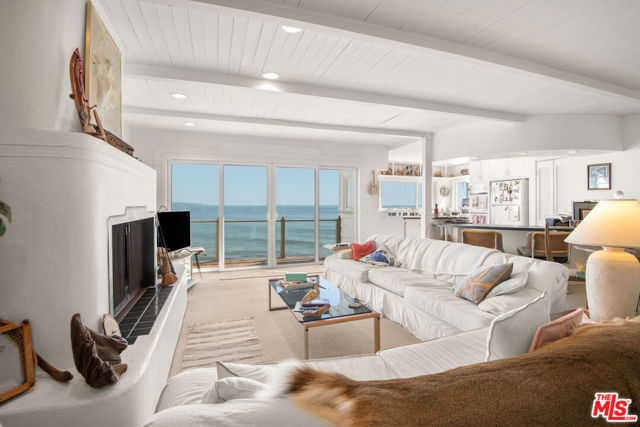Malibu Beach Front Beach House !  Best Malibu Beach Buy !   Amazing opportunity to own a 3story beach house on Las Tunas beach with expansive decking on all three levels and stunning views of the Queen's necklace and Santa Monica Bay. This quintessential California beach house has a nice open floor plan great room on the main level with attached 2 car garage. The second story consists of two bedrooms, including the primary bedroom with private expansive deck and primary bath. The second bedroom has double height ceilings with stunning architectural wooden curved ceiling continuing into the third story loft and outside to partially cover the third story appx. 400 sq. ft. deck. The home is located on a great beach only 10 min to both Santa Monica and Malibu's main shopping center/Pier. See Video link for 360 virtual tour (mattaport) of property.