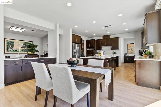 Dining space with recessed lighting and light wood-style floors
