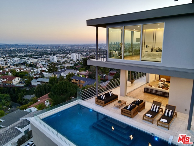 7007 Los Tilos Road Los Angeles, California Iconic panoramic views from the Hollywood sign to the Pacific Ocean paint the backdrop for this stunning modern residence sitting on a nearly 1-acre private knoll. A long private driveway leads to this 4-bed, 4.5-bath completely remodeled marvel. A sensational living room with fireplace, open concept custom kitchen, family room, temperature-controlled wine display, dining room, bedroom and 1.5 baths complete the main level. Floor to ceiling Fleetwood doors make indoor outdoor living a breeze. The inviting pool is perched with unsurpassed views of the heart of the City. Multiple decks, patios, a grassy yard and outdoor entertaining spaces are positioned to take in the picturesque scene. Three en-suite bedrooms are sited upstairs, each with breathtaking views. A 3-car garage and motor-court provide ample parking. Convenient to the best nightlife, restaurants, hiking trails and entertainment. A singular masterpiece years in the making. Must see.