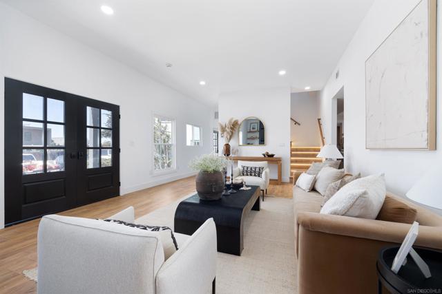 Large living room and entry area, custom fireplace with built in cabinets and floating shelves