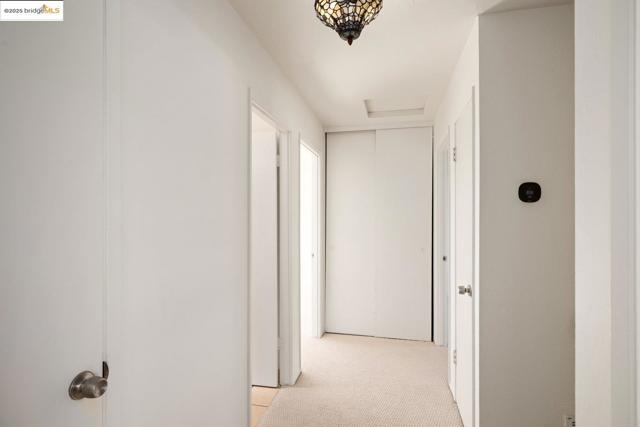 Hall featuring linen, storage, furnace closets and attic access