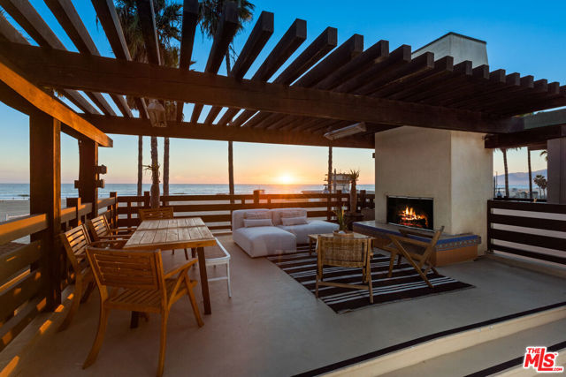 Only moments to the sand, this sun-filled beach abode offers a rare opportunity to own front row, unobstructed ocean views from one of Los Angeles' most iconic neighborhoods. Showcasing over 3,400 square feet of impeccable design and finishes, this 3-bedroom, 4-bathroom masterpiece has it all. The main level is perfect for entertaining, including a "beach-formal" living room, dining space, and stunning gourmet kitchen with bespoke white cabinetry, all with breathtaking panoramic ocean views. The richly detailed and private primary suite has a spacious lounge area and a spa-like bathroom with rainfall shower-head and walk-in closet. Ascend the meticulously curved staircase to the upper level featuring a family room with built-ins, bonus game area, and private vista terrace with fireplace overlooking the beach. The lower level includes a spacious beach-access guest suite with en-suite bathroom and patio. Not to be overlooked, the property has a private 4-car attached garage, ensuring ample parking in one of LA's most bustling communities. This is Venice ocean front living at its best!