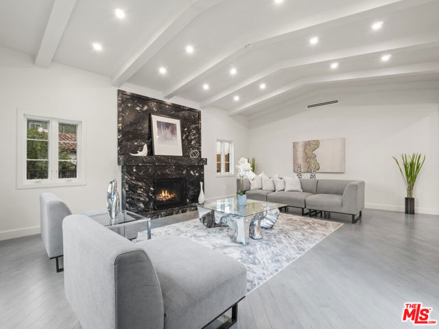 301 S Almont Drive Beverly Hills, California Discover luxury & harmony in this stunningly remodeled 3bed/4bath home with newly built spacious rear unit behind the main house.Impeccably remodeled with elegance, style & upgraded systems. Open floor plan seamlessly connects the interior & exterior spaces letting natural light in from all angles. Formal entry leads into the living room with gorgeous custom fireplace.Property features fresh white custom cabinetry in kitchen and bathrooms with matching Calacatta quartz countertops. Hardwood floors throughout and a picture perfect window and fireplace in the living room. Dining area and eat-in kitchen with large kitchen, professional appliances & a breakfast area perfect for anyone who likes a lively kitchen.Great master bath with large closets, shower and bathtub with porcelain flooring throughout & floor to ceiling porcelain-marble and/or mirrored tiles. Back unit features a spacious living room with fireplace, full kitchen with island and stainless-steel appliances. Full bathroom with impeccably contrasting vanity and washer/dryer in unit. ADU has its own address 9000 Gregory way. The fabulous backyard offers great space for entertaining w/patio and drip irrigation garden that beautifully drapes the fence.