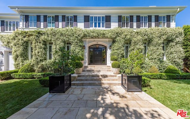 Gorgeous traditional set on approx 32,000 SF flat double lot in the highly sought-after Brentwood Park neighborhood. This 6BD 10BA timeless gem sits behind a gated drive and lush hedges to provide ultimate privacy. Step inside to experience the warm and inviting atmosphere that was reimagined by famed architect Steve Giannetti. 10,200+ SF main house features rich hardwood floors, high ceilings, thoughtfully designed formal living/dining rooms, library, and chef's kitchen. Second level features stunning primary suite with sitting area, spa-like dual bath, and custom closet. Main level French doors open to outdoor living area with fireplace, expansive grassy lawn, gardens, firepit, swimming pool, spa, and poolside cabana. Additional amenities include home theater and fitness center. A one-of-a-kind estate offering privacy, security, and exquisite design in one of the best locations in Brentwood.