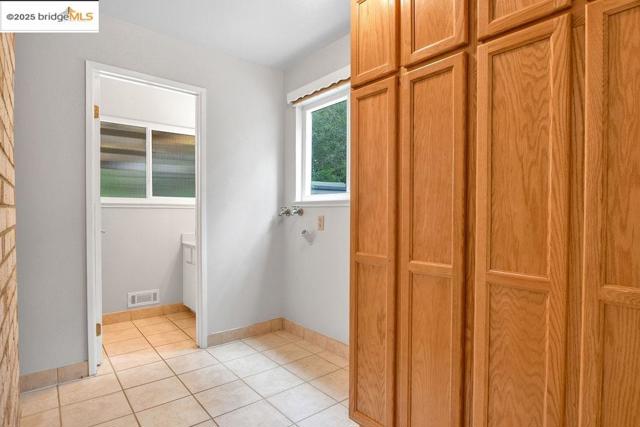 Bathroom featuring light tile patterned flooring and baseboards