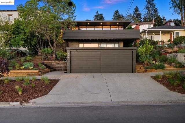 Modern home with concrete driveway, a balcony, and an attached garage