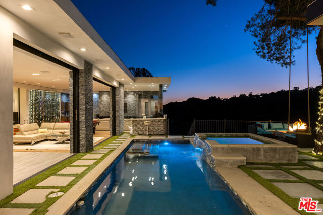 3001 Benedict Canyon Drive Beverly Hills, California Live life at the top! Perched on one of the largest lots in the elevated part of Benedict Canyon called Tennis Row, the Bella Estate boasts a 7,100 sq ft home, complete with 6 bed, 6.5 bath & was completely updated last year. On the market for the first time in 21 years, the home is magnificent, moving through a glass door entrance & equipped with water features throughout, amenities include 2 kitchens, 2 living rooms, 3 gated entrances, a 4 car garage & parking for up to 20 additional cars. The lot is 1.6 acres (67,000 sq ft) and 46% flat! Bonus: The Bella Estate is shovel-ready & provides an opportunity to build a 22,000 sq ft world-class lifestyle estate with unobstructed 360 city & canyon views. After passing a three-year approval process, this property has been grandfathered in for construction of this size (no new permit approvals over 10K sq ft). Proposed plans provide for the ultimate California lifestyle - with exclusive amenities including media room, gym & wellness center, 50 ft infinity pool, spa pool, guardhouse, attached 1,200 sq ft guest house, ponds, waterfalls, sports court, firepit, maid quarters, service & delivery entrance, and two resident entrances with a circular driveway. Luxurious walls of glass showcase views throughout the house. Views from all en-suite bedrooms make the project incredibly special. This is a once-in-a-lifetime opportunity to own this special home with plans destined for significance.
