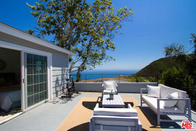 Ocean and Mountain View Galore - Extremely rare opportunity to own a piece of paradise sitting on a promontory overlooking pristine ocean and Solstice canyon views for under $2M in Malibu! Fresh from a cosmetic renovation, this exquisite 3-bedroom, 2.5-bath retreat exudes idyllic indoor-outdoor living and a vibrant atmosphere showcasing new flooring and paint throughout, updated kitchen and bathrooms, and newly landscaped grounds. The main floor offers a bright and airy living room, gourmet kitchen equipped with stainless steel appliances, spacious dining room, and an extra large bonus room. Step outside through the sliding glass doors and be greeted by a massive 950 SF entertainment deck where the breathtaking mountain views provide an awe-inspiring backdrop. Unwind in the large built-in jacuzzi or host memorable gatherings with family and friends in this expansive outdoor space with an abundance of room for all your entertaining and relaxation needs. Upstairs, you'll discover two guest bedrooms and a primary suite that serves as a tranquil haven. Sliding glass doors open from the primary bedroom to a beautiful large upper deck also accessible from the main floor inviting you to soak in the expansive ocean vistas. Located under a 10 min drive from PCH and the beach, this newly updated home offers the best of both worlds peaceful canyon living combined with easy access to the coastal lifestyle. Don't miss the chance to make this serene retreat your own and experience the unparalleled beauty of ocean and mountain views in this stunning Malibu property.