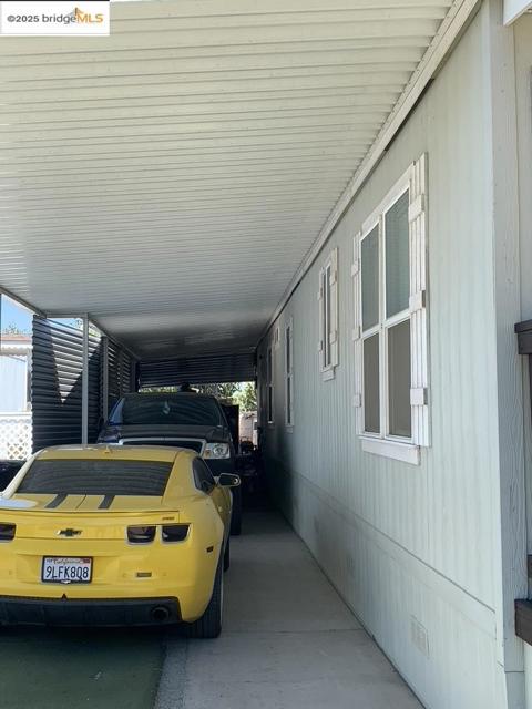 View of vehicle parking with a carport