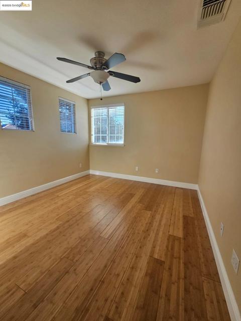 Empty room with baseboards and light wood-style floors
