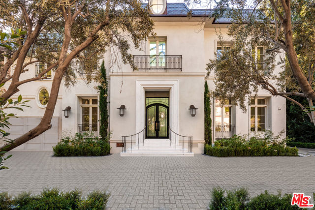 A stunning Classic French-inspired Estate, sitting on a prime Bel-Air lot, with 5-bed 8-baths that is sure to impress. Rare opportunity to buy in a prestigious location near the Bel Air Hotel on approximately 35,000 square feet of manicured land. Upon entering from a private gate with a stone paved driveway. Walk in through the grand foyer and spiral stone staircase that showcases the 25+ feet high ceilings in the Foyer with exquisite crown molding. The home features imported marble, fine hardwood floors, and rare precious stones in the bathrooms and countertops. The main floor consists of a spacious living, a dining room, a gourmet kitchen with an oversized marble island, a breakfast room with a butler's pantry, a game/billiards room, and a gorgeous library/office. Not to mention the custom wine cellar. Going up the sprawling staircase, the upstairs is home to the master suite boasting his & hers closets, imported fine marble slabs for the master bath floor, impeccable walk-in shower, two terraces with tree top and canyon views, plus three additional en suite bedrooms. Luxurious built-in cabinetry in most rooms for ease of storage. Backyard pool and spa. In addition to all, the garage is spacious enough to accommodate cars with beautifully crafted epoxy floors. To the back of the house is a large covered California room with a planned outdoor fireplace, a planned lighted lap pool and heated jacuzzi, planned shower booths and restroom, a planned covered BBQ kitchen, all being surrounded by lush green privacy tree lines. This is a unique opportunity to own this one-of-a-kind property for you and your family. Come to see this fabulous Estate and fall in love! The property is roughly 95% complete and to be delivered "as-is".