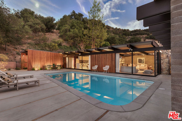 272 Mesa Lila Road Glendale, California The Gordon & Hildred Goetschel House, Ray Kappe FAIA (1954). The architect's first single family residence, and the start of a pioneering and influential career that would span nearly 7 decades. At Mesa Lila, you see Kappe's explorations into a vocabulary that would signify his early works. The emphasis is on spatial expansion, focusing inhabitants towards the surrounding nature and distant views. Horizontal massings of redwood siding and unpainted masonry block give privacy to a glass walled pavilion. Natural light spills in from all directions, animating the space and casting slow moving shadows throughout the day. The property has just undergone a complete overhaul of systems and restoration of finishes. This is the latest project by HabHouse, who have built their reputation upon sensitive rehabilitations of architectural properties. They have reinstated original detailing wherever lost and refurbished it wherever intact. The pool, original to the home and also a Kappe design, has now been brought into the 21st century with new equipment, plaster, tile, and coping. Seemingly a world away amongst the native California Live Oak trees of the Verdugo Woodlands, yet in close proximity to La Canada Flintridge, and rarely more than a 15 minute drive to Silver Lake or Echo Park.