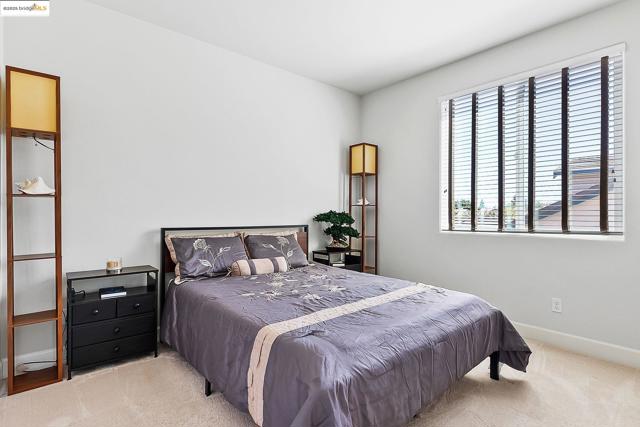 Bedroom with carpet floors and baseboards
