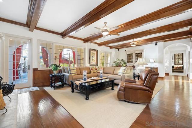 Great Room, featuring stunning wood beams, speaker system and fireplace