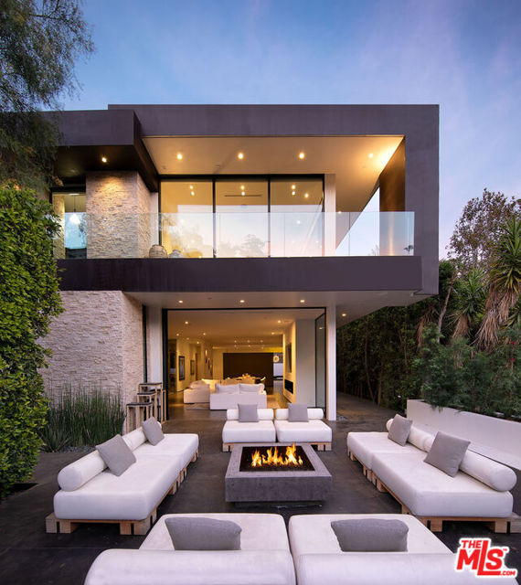 Nestled on West Hollywood's Rising Glen Road, just moments from the Sunset Strip, this gated modern home showcases quintessential California living. Boasting carefully curated materials and floor to ceiling windows throughout. The interiors flooded with natural light, creating an indoor/outdoor haven. With a main-level guest room, two upstairs bedrooms, and an expansive primary suite featuring a walk-in closet, lounge, spa-like bath, and balcony, every space is designed for comfort. The private backyard features the perfect outdoor entertaining space with pool, spa and outdoor bbq, all just steps away from the best food and entertainment West Hollywood has to offer.