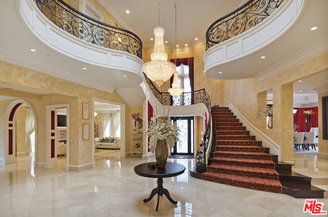 2229 Summitridge Drive Beverly Hills, California This Stunning Contemporary Mediterranean estate is behind gates in a prime location just outside exclusive Beverly Park and is complete with fabulous city and mountain views. Almost 10,000 square feet of custom construction, soaring ceilings and top of the line finishes and features. Dramatic grand entry and impressive foyer with an elegant staircase design. The gourmet kitchen features expansive center island/breakfast bar and imported Italian counter tops. The grand staircase leads to a gorgeous master suite with sitting area, dual designer marbled bath, and balcony. Features include 7 bedrooms, 10 baths, a unique formal ground floor ballroom, light filled formal living room, multiple entertainment areas, gym, sauna, elevator, beautiful marble, stone and wood floors, sparkling waterfalls, pool, spa, fire pit and a grassy yard. Designed to be a flawless meld of family living and grand entertaining in high style. A remarkable value for this square footage in such a prime location.