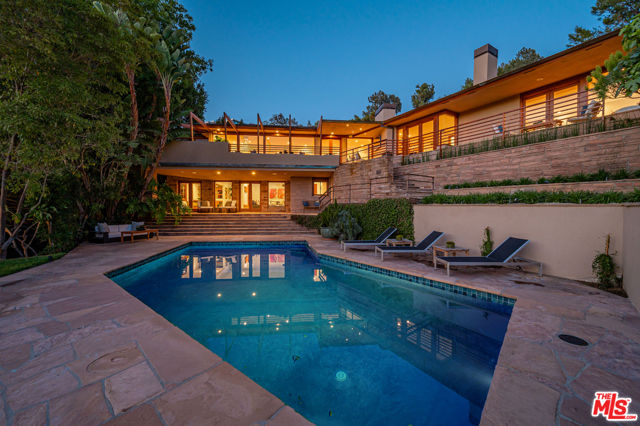 9454 Lloydcrest Drive Beverly Hills, California Located in the prime Crest streets down a long driveway, this fabulous gated estate with spectacular canyon and verdant views is a prime example of mid century classic modern architecture at its best. Lloyd Wright inspired chic private home is completely remodeled to todays living standards. Featuring a stunning courtyard with water feature, new kitchen with brand new Thermador appliances, new bathrooms, lutron lighting system, open floor plan, high ceilings, and a great indoor outdoor entertainment flow. Wet bar is located in recreation room for a poolside entertainment convenience. There is a second gated entry that provides the potential for a guest suite or home office utilizing the entire lower level separate from the main level. 4 additional bedrooms, office and den complete this unique home.