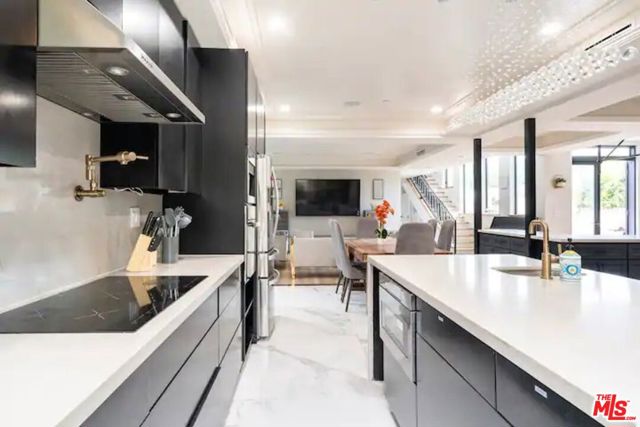 Kitchen with built in microwave, electric stove, coffee maker, and oven