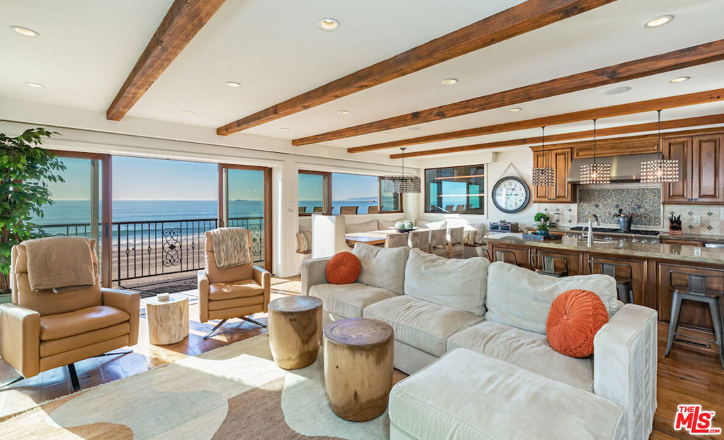 This one-of-a-kind, dual-residence beach-compound, sited on the sand of the world famous, Manhattan Beach Strand is decorated from dusk until dawn with unobstructed, emotional ocean views. Smartly configured with the entertainer in mind, the front, strand-facing, home consists of 4 bedrooms and 3.5 bathrooms, in ~3,500 SF. The main level is open-concept, connecting generously sized living and dining areas, a kitchen adorned with Thermador appliances, outdoor spaces, and office with built-ins. The lower level is a massive flex space which can function as a gym, family room with bar, or home theater, which opens directly to the beach. The upper home, in ~2,500 SF, is appointed with 4 bedrooms and 3.5 bathrooms. Amenities include: secured entry and cameras, large storage area, fire-pit, built-in grill, lush landscaping, wine fridges, automatic shades, Vantage lighting, Richard Marshall flooring, water purifier, heated floors, and garage parking for 6 cars with 2 spaces on the apron.