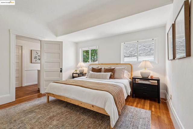 Bedroom with wood finished floors and baseboards