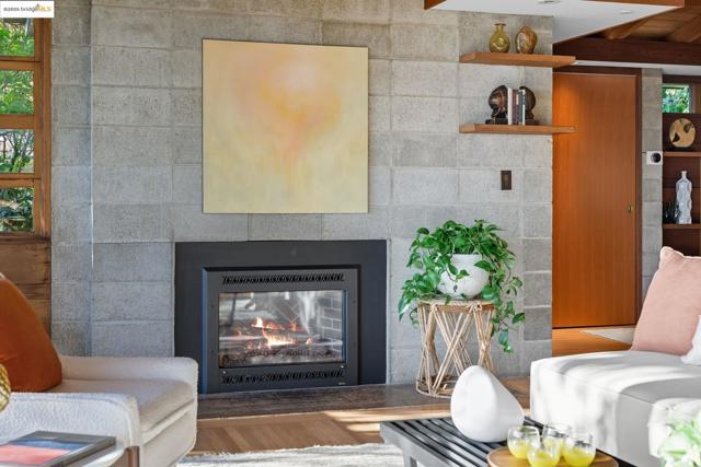 Living area with wood finished floors and a glass covered fireplace