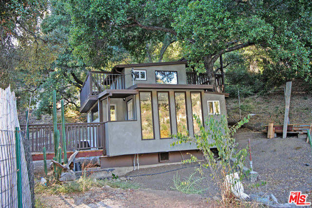 543 Fernwood Pacific Drive Topanga, California Stunning Views from this recent update guest home. Imagine walking over a lovely wooden bridge while the seasonal creek flows below, into the main living area with floor-to-ceiling windows, Hardwood floors, a tiled bathroom, and the cutest little kitchen so very efficient. This is a minimalist dream home. There is upstairs decking with mountain views and a loft space that would be perfect for an extra storage area or a meditation room. Located within minutes of PCH, SFV, and the beach. Easy to show text agent.