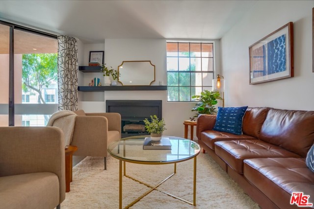 750 N Kings Road 302 Los Angeles, California Newly renovated with designer finishes, this bright top floor unit faces West. This home features an open kitchen and brand new stainless steel appliances and new engineered hardwood floors through out. A gas fireplace in the living room keeps the space warm during the winter months. Large windows overlooking Kings Road and the hills! The bedroom and living room both open to the patio...a perfect place to start and end your day! There's a walk-in closet in the bedroom and the bathroom features dual side by side sinks and a bathtub with shower. The building hosts a gym and spa plus a stunning rooftop with a BBQ to enjoy the views of the Hollywood Hills and City! There is plenty of guest parking in a gated garage.