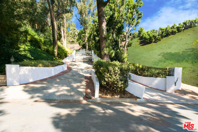1242 Lago Vista Drive Beverly Hills, California Two huge separate lots with views in Beverly Hills proper for the price of one! These properties are gated up along majestic driveway, which opens up onto the two huge legal lots with views. Nestled on one lot is a charming 5,950 square foot house with a swimming pool. The other lot has a huge flat pad with canyon and city light views. This is a great find for a developer to build two spec houses or a fantastic opportunity for an owner user to build a fabulous private compound in Beverly Hills proper, directly across the street from a $40 million estate. Two APNs; 4350-018-029 and 4350-018-021