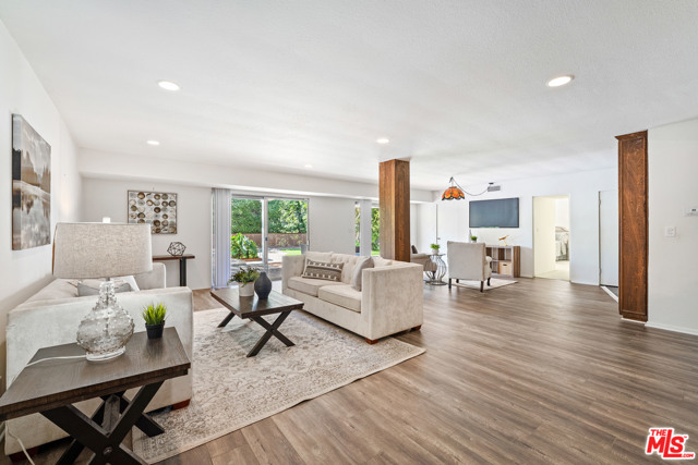 1169 Angelo Drive Beverly Hills, California This Beverly Hills home presents an exceptional opportunity to redesign. On an 10,000+sf lot, this home offers a large open entry featuring a 360 panoramic fireplace which has been thoughtfully preserved and remains true to its original Architectural design. The open floor plan has five en-suite bedrooms with the owners suite on the main floor. The private rear grounds feature: a pool, spa and lush greenery. Perfect for developers and owner users.