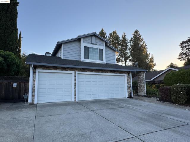 Garage at dusk featuring driveway